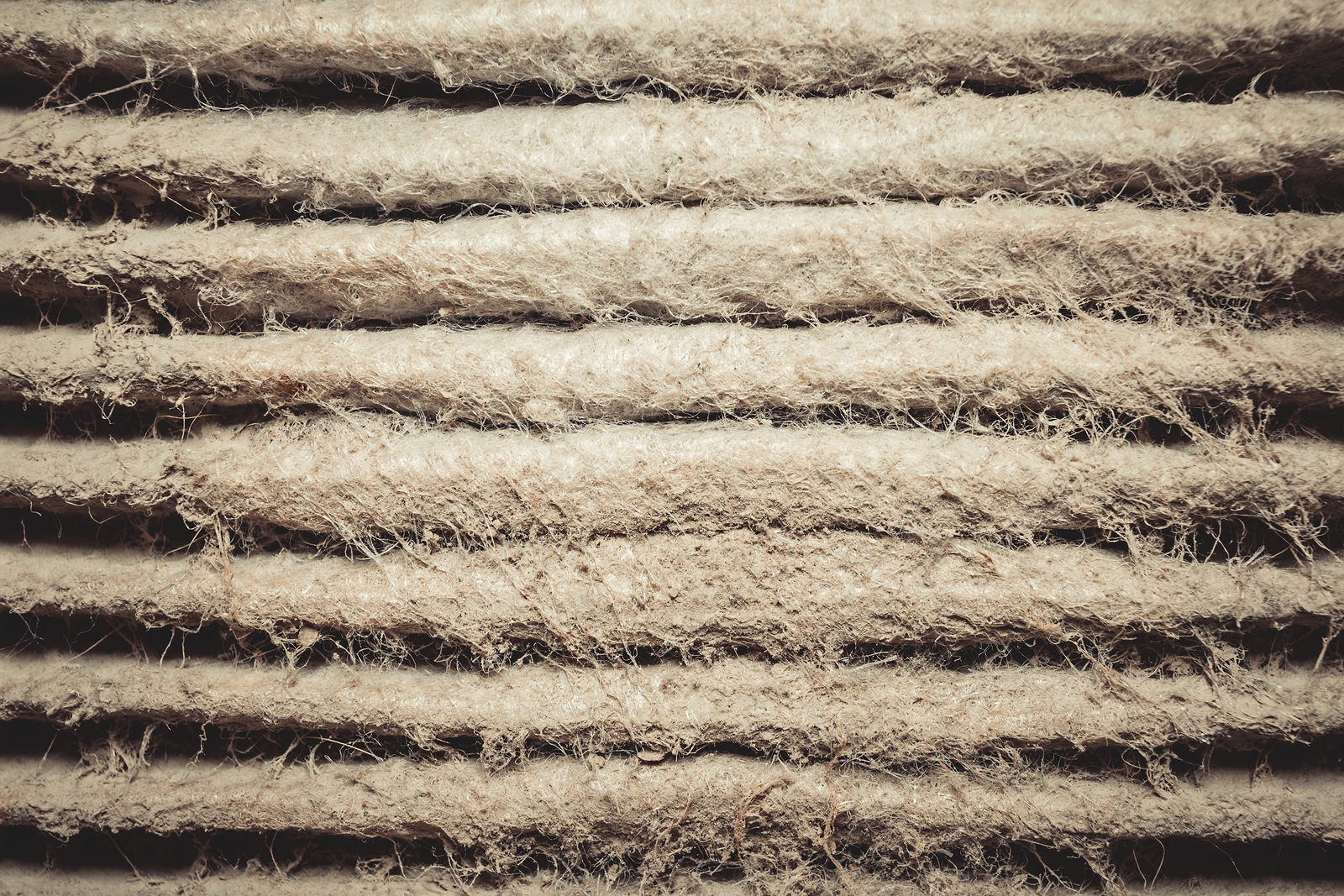 Detailed fragment of dirty air filter surface. Background texture.